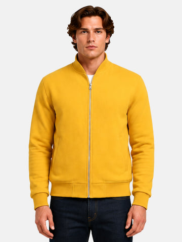 Man wearing a yellow wool varsity jacket with silver zip front and tonal ribbing