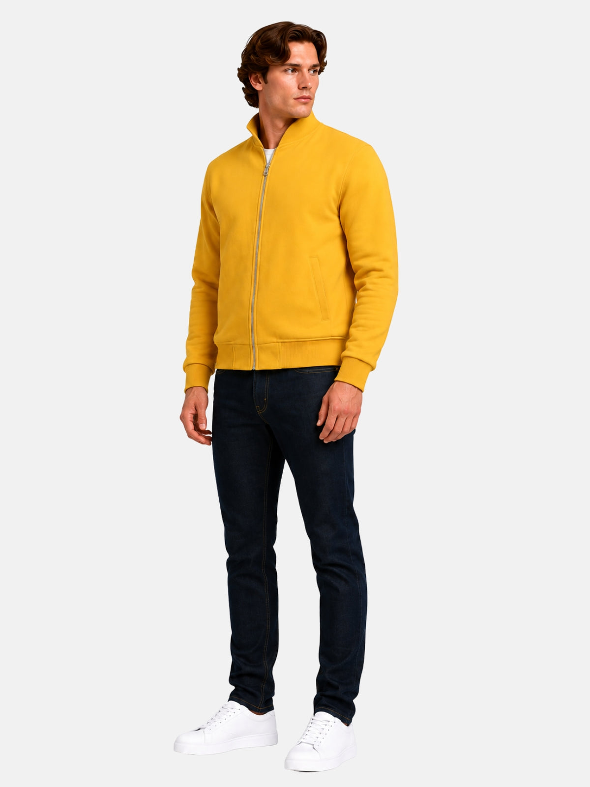 Full-length view of model in golden yellow varsity jacket with dark denim